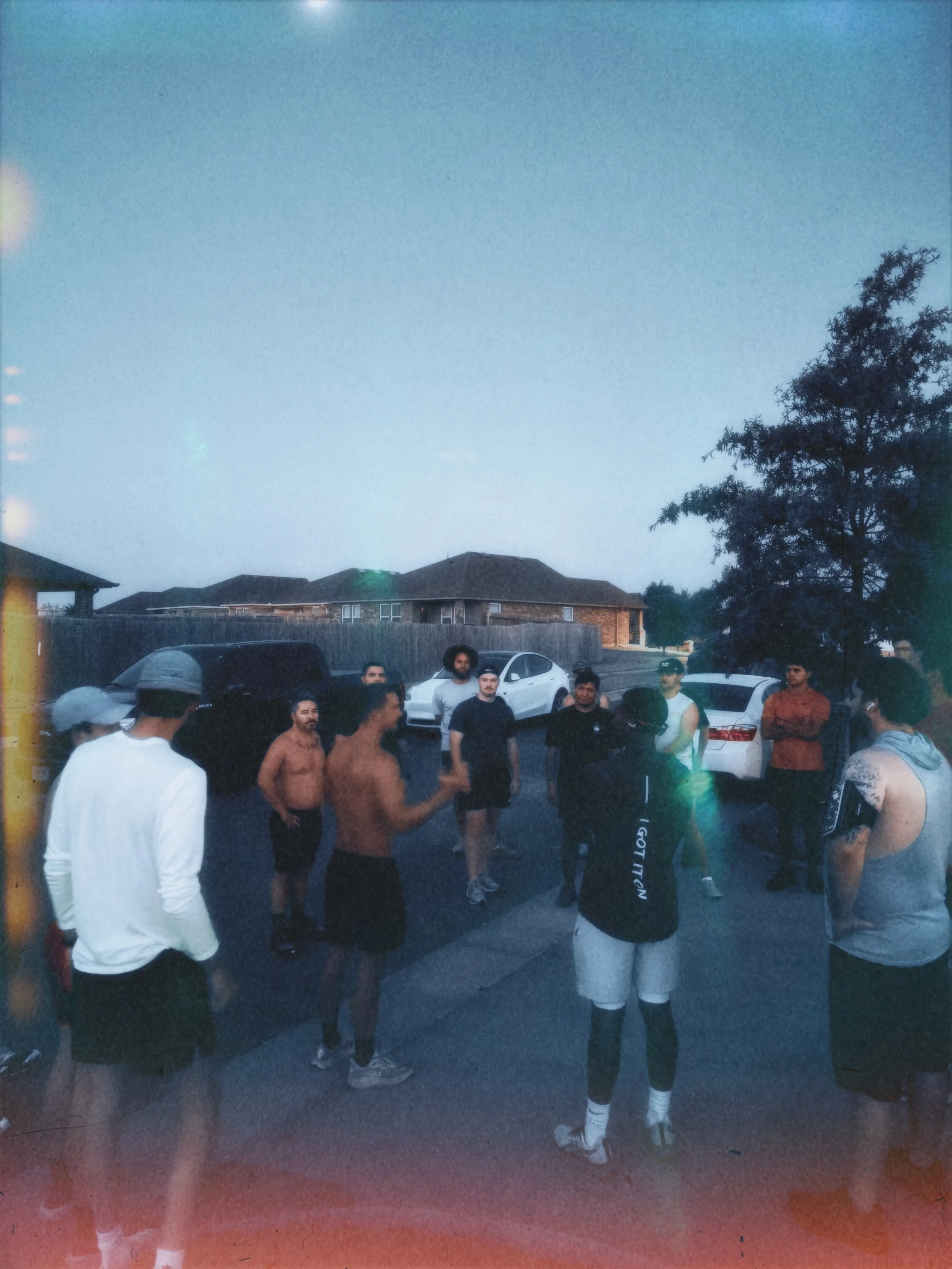 Men in a circle talking before a neighborhood run
