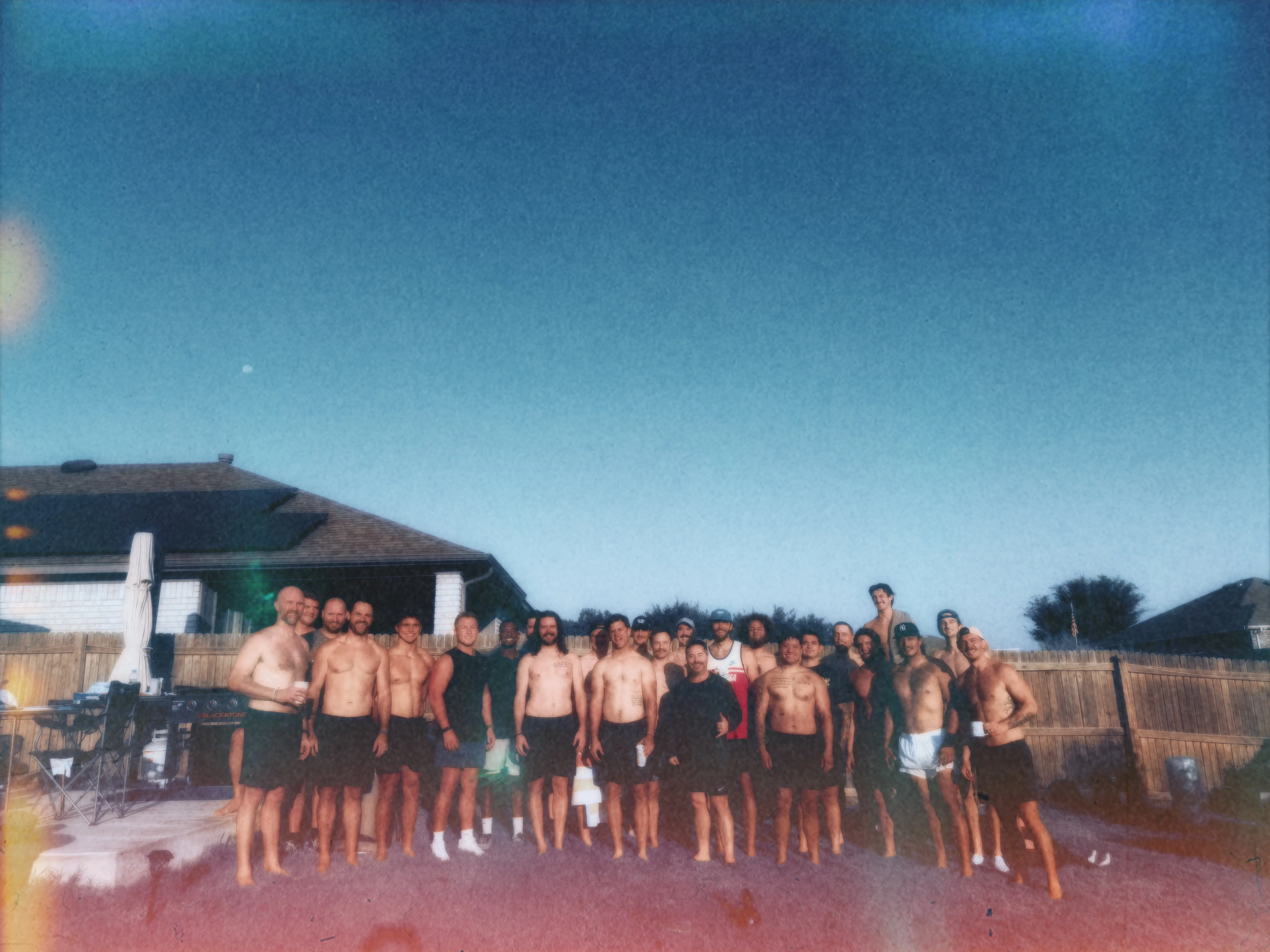 Large group photo of Meantime men in a backyard