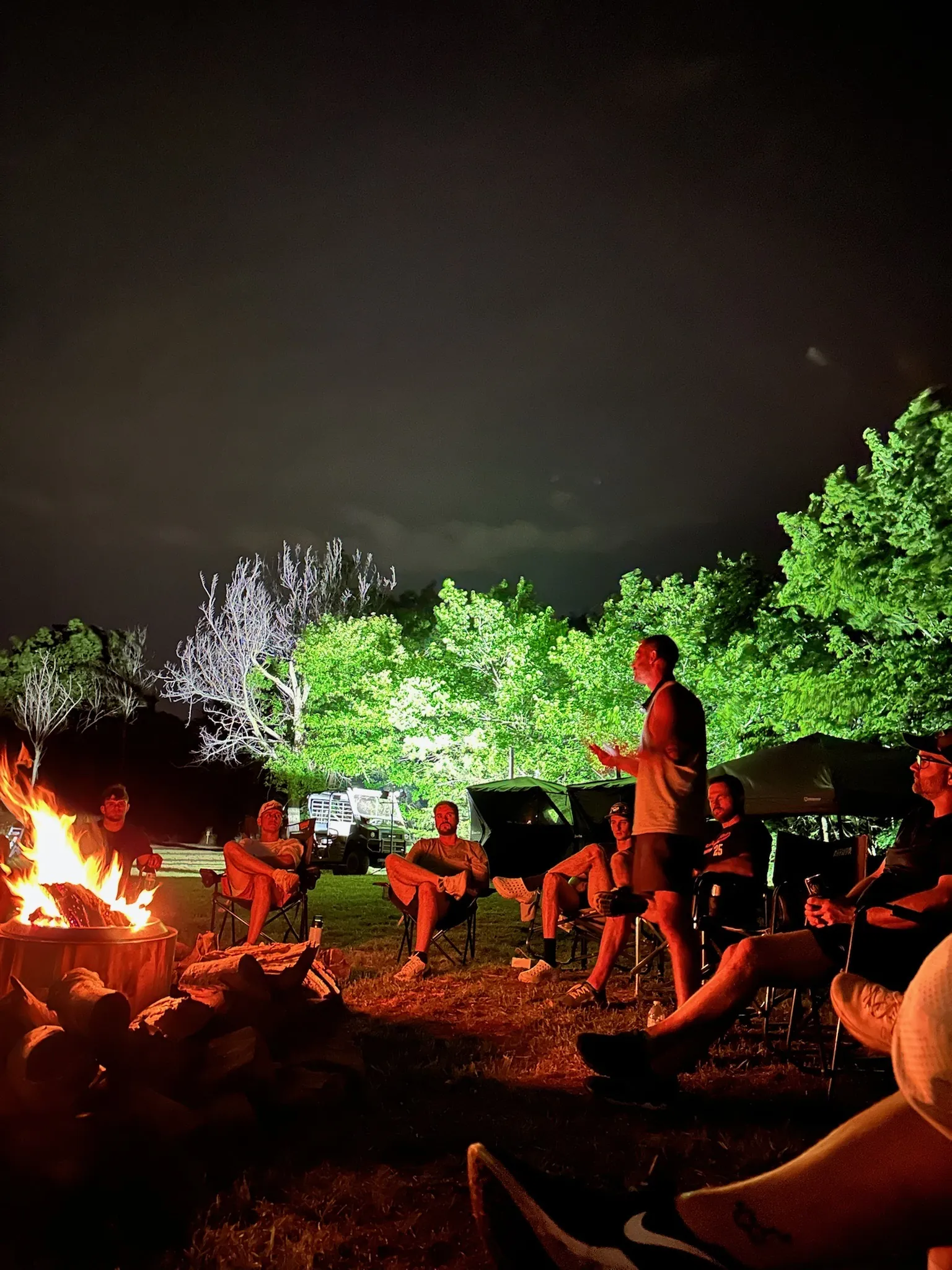 Men talking around the Runathon campfire