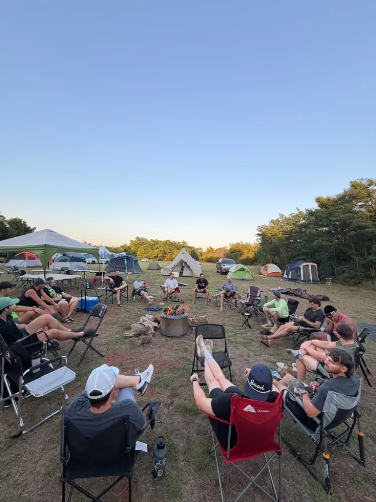 Men circled around a fire to chat